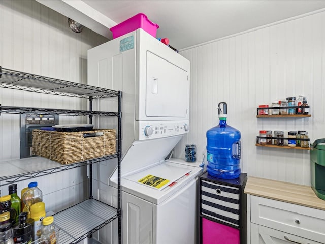 laundry area with stacked washer and clothes dryer