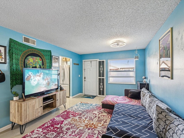 living room with tile patterned flooring and a textured ceiling