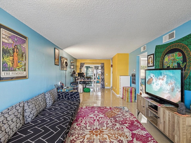 tiled living room featuring a textured ceiling