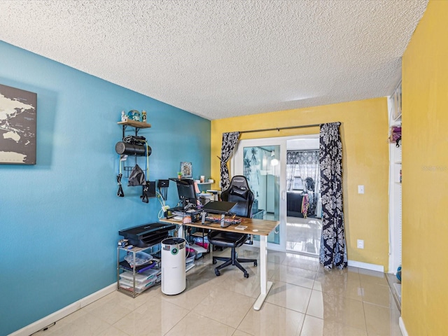 tiled home office featuring a textured ceiling