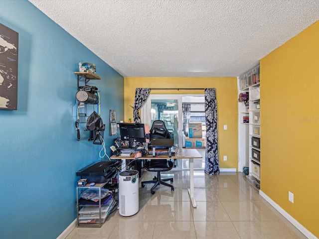 office area featuring tile patterned flooring and a textured ceiling