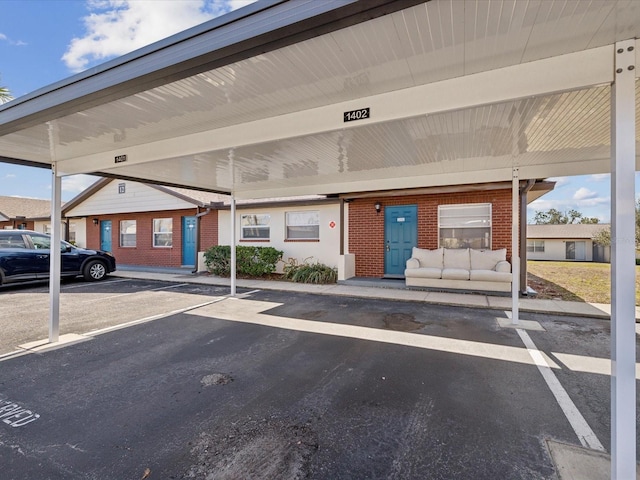 view of parking / parking lot featuring a carport