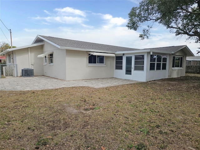 back of property featuring central AC unit, a yard, and a patio area