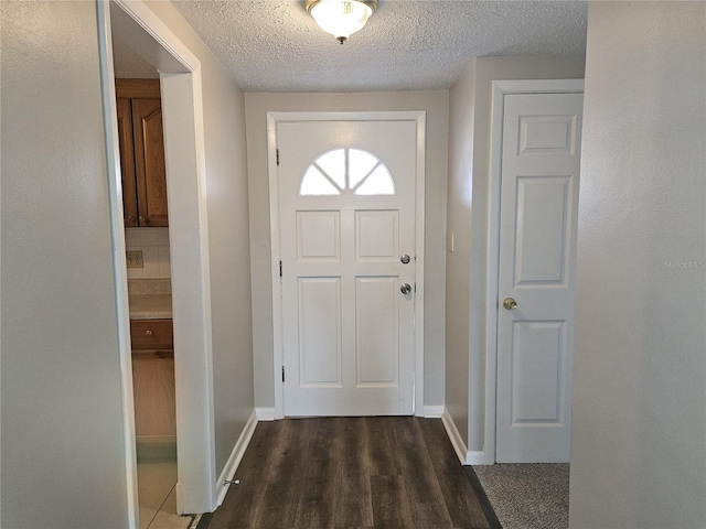 entryway featuring dark hardwood / wood-style floors and a textured ceiling