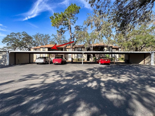 view of parking / parking lot featuring a carport