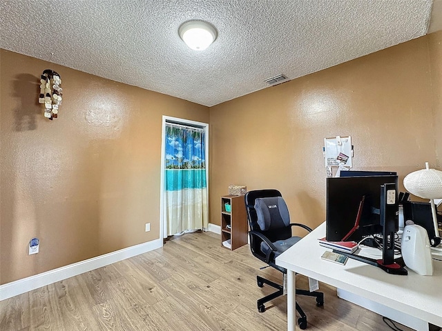 office space featuring light hardwood / wood-style floors and a textured ceiling