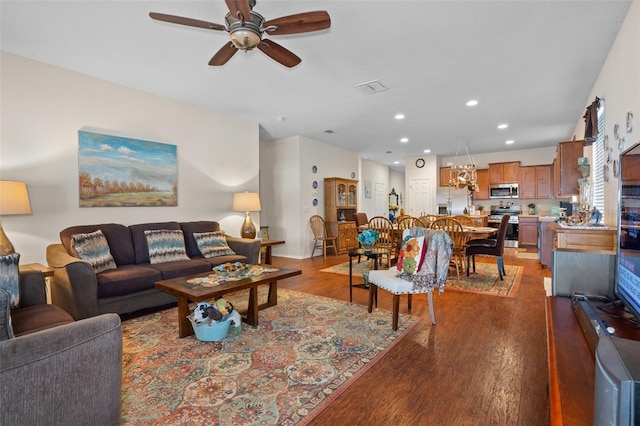 living room with wood-type flooring and ceiling fan