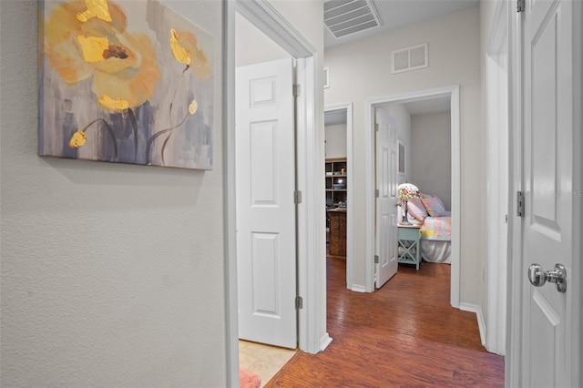 hall with hardwood / wood-style flooring