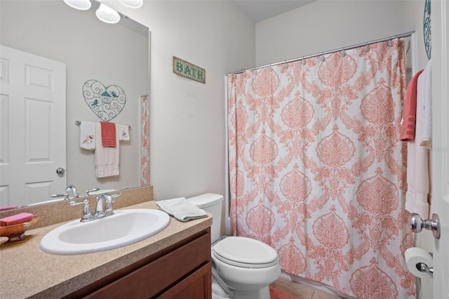 bathroom featuring vanity, curtained shower, and toilet