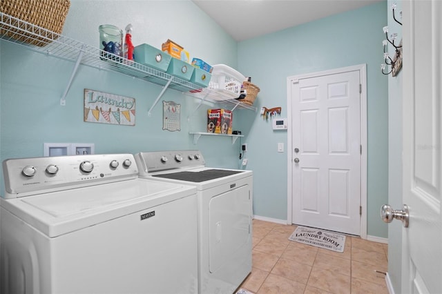 washroom with light tile patterned flooring and washer and clothes dryer