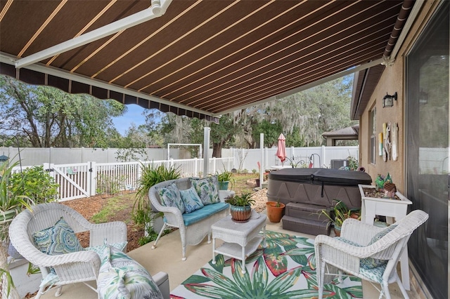 view of patio / terrace with an outdoor living space and a hot tub