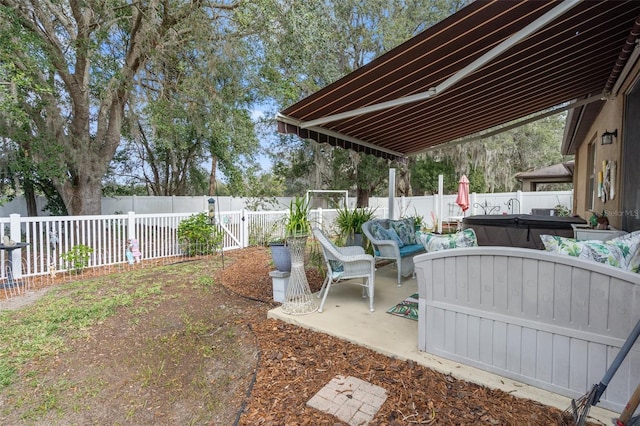 view of patio with an outdoor living space and a hot tub