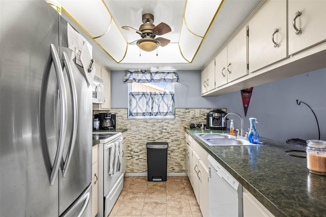 kitchen with sink, white appliances, white cabinets, and ceiling fan