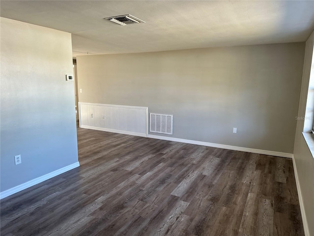 unfurnished room featuring dark hardwood / wood-style flooring