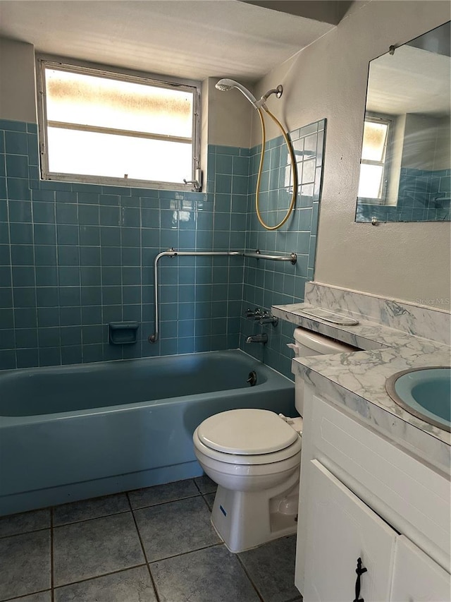 full bathroom with vanity, tiled shower / bath combo, a wealth of natural light, and toilet