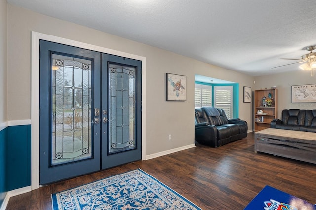 entrance foyer featuring french doors, ceiling fan, dark hardwood / wood-style floors, and a textured ceiling