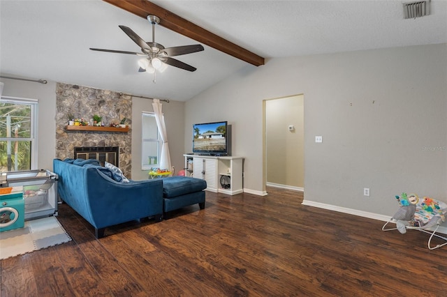 living room featuring a stone fireplace, dark wood-type flooring, vaulted ceiling with beams, and ceiling fan