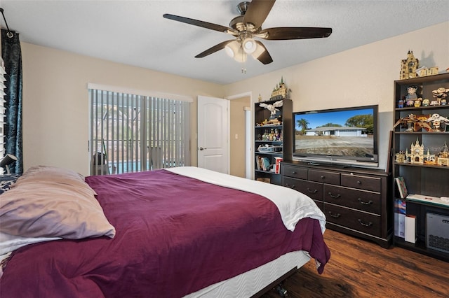 bedroom featuring ceiling fan, a textured ceiling, access to exterior, and dark hardwood / wood-style flooring