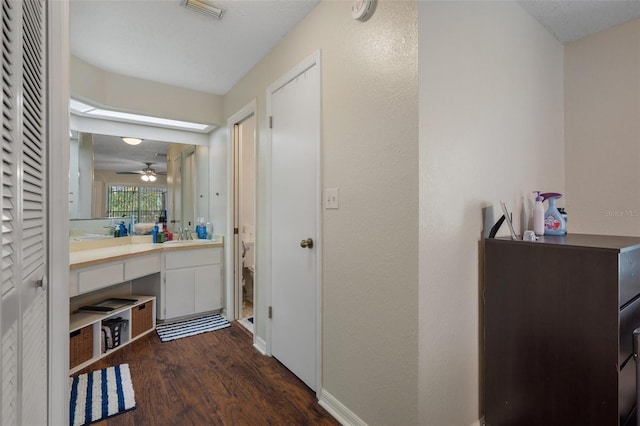 bathroom with wood-type flooring, toilet, and vanity