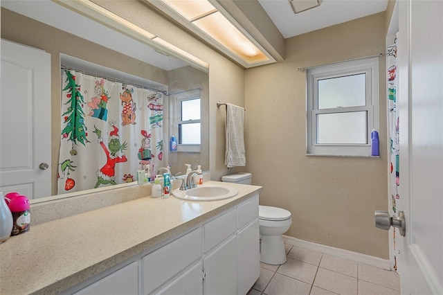 bathroom with tile patterned flooring, vanity, and toilet