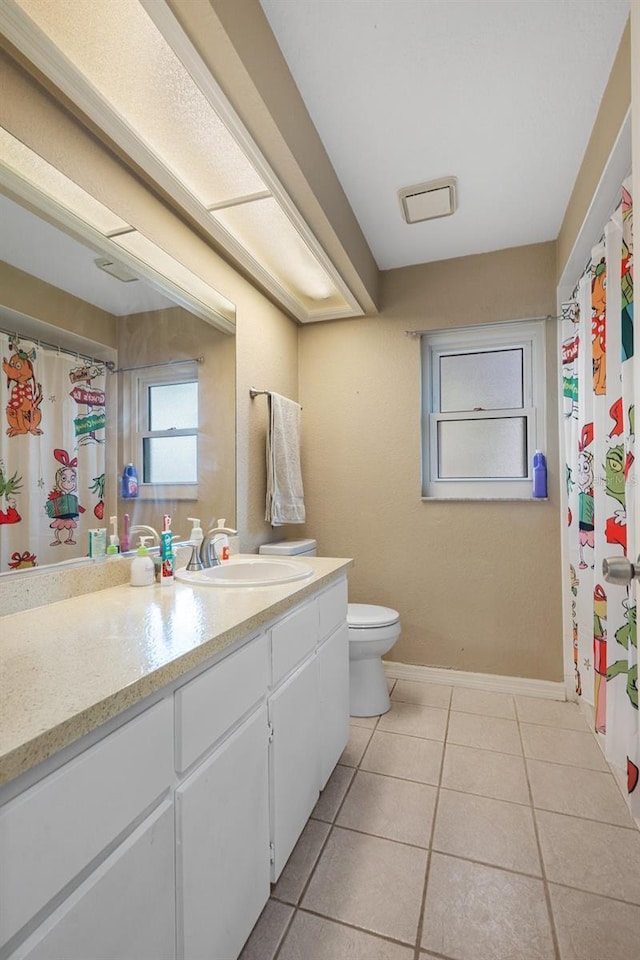 bathroom with vanity, toilet, and tile patterned flooring