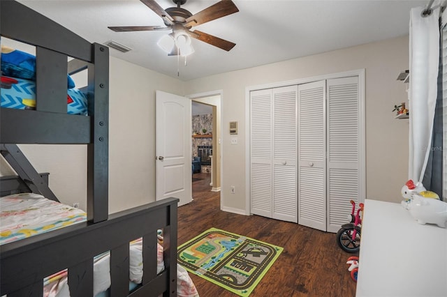 bedroom with dark hardwood / wood-style floors, ceiling fan, and a closet