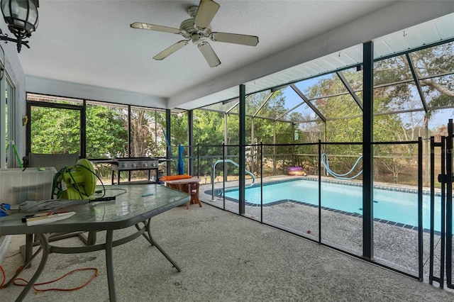 view of swimming pool with a lanai, a patio area, and ceiling fan