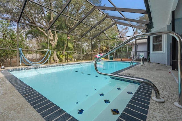 view of pool featuring a patio and glass enclosure