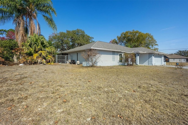 view of side of property with a garage and a yard