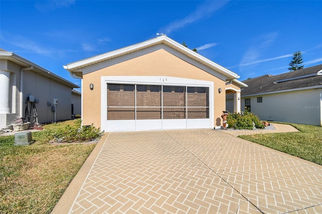 view of front facade with a garage and a front lawn