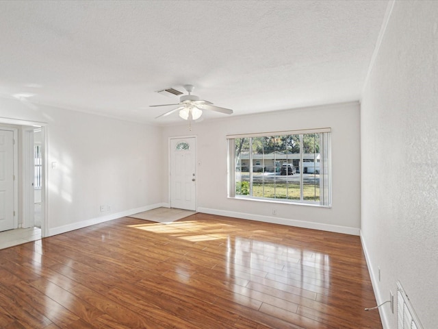 spare room with ceiling fan, light hardwood / wood-style floors, and a textured ceiling