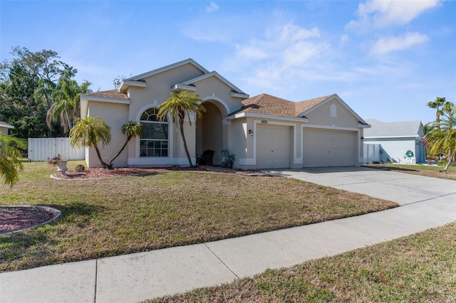 view of front of house with a garage and a front yard