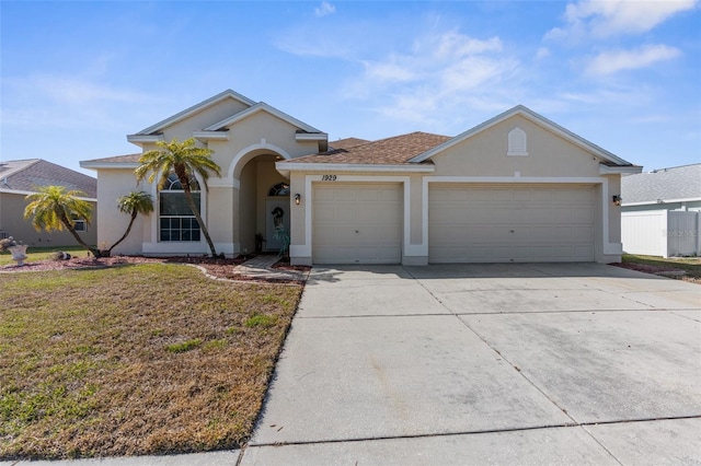 ranch-style house with a garage and a front yard