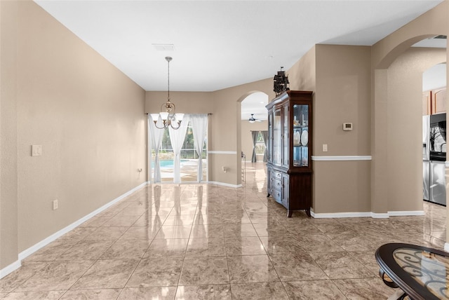 unfurnished dining area with a chandelier