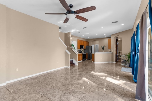 unfurnished living room featuring ceiling fan