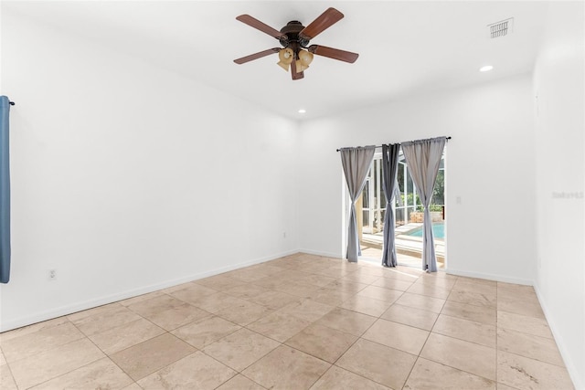 tiled empty room featuring ceiling fan