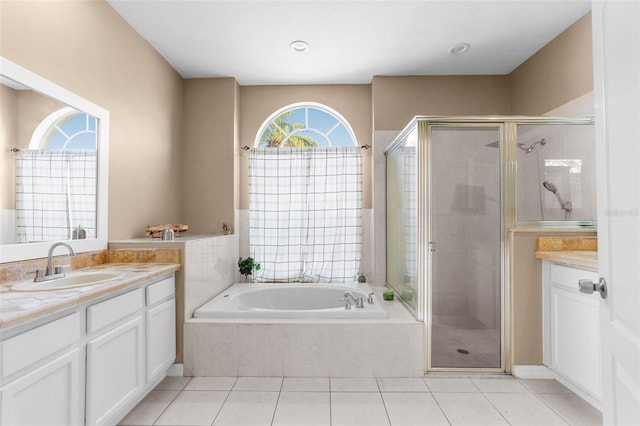 bathroom featuring vanity, tile patterned floors, and plus walk in shower