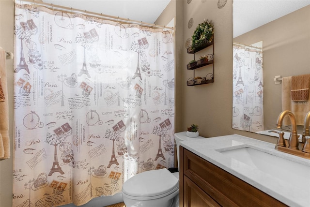 bathroom featuring vanity, toilet, and curtained shower