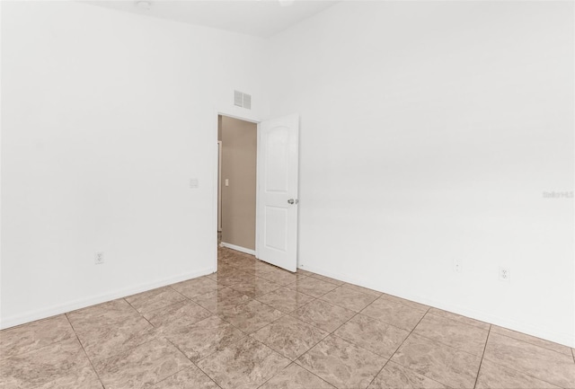 unfurnished room featuring high vaulted ceiling