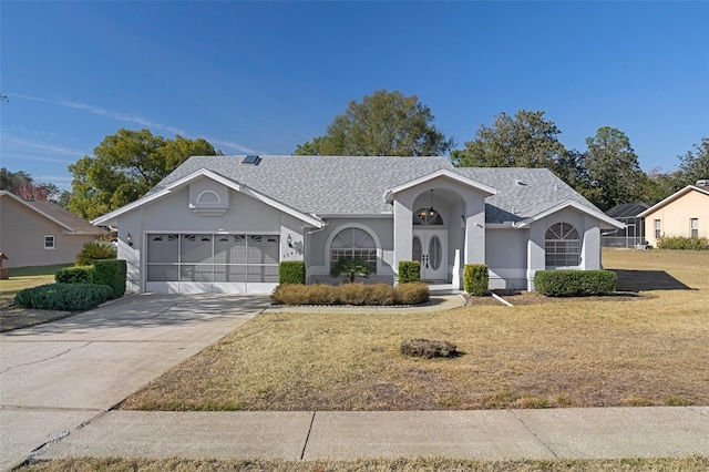 ranch-style house with a garage and a front lawn