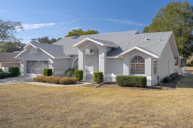 ranch-style home with a garage and a front yard