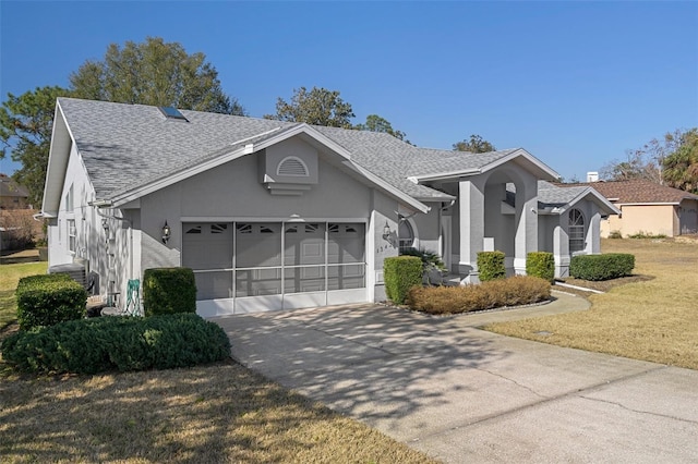 view of front of property featuring a garage and a front lawn