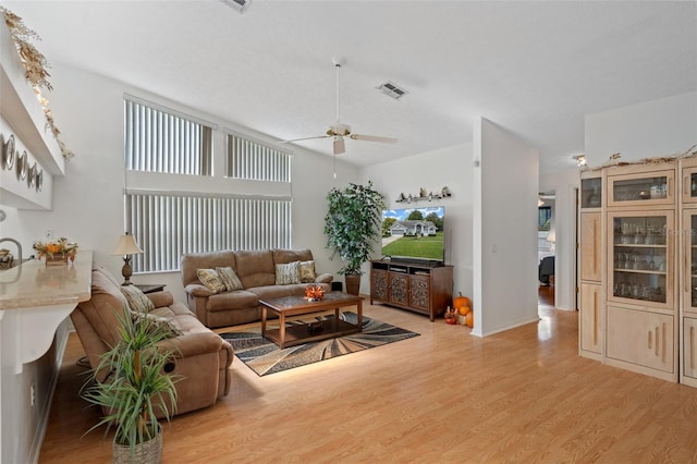 living room featuring ceiling fan and light wood-type flooring