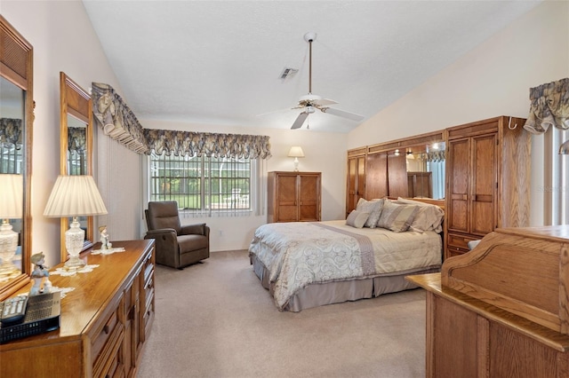 carpeted bedroom with vaulted ceiling and ceiling fan