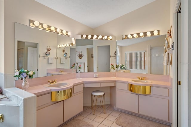 bathroom featuring tile patterned flooring, vanity, lofted ceiling, and a textured ceiling