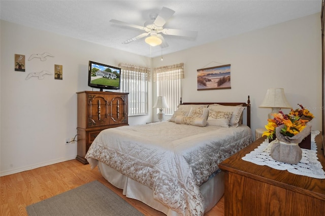 bedroom featuring hardwood / wood-style floors, a textured ceiling, and ceiling fan