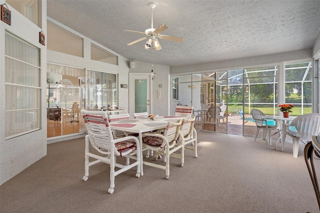 carpeted dining room featuring ceiling fan, vaulted ceiling, and a textured ceiling