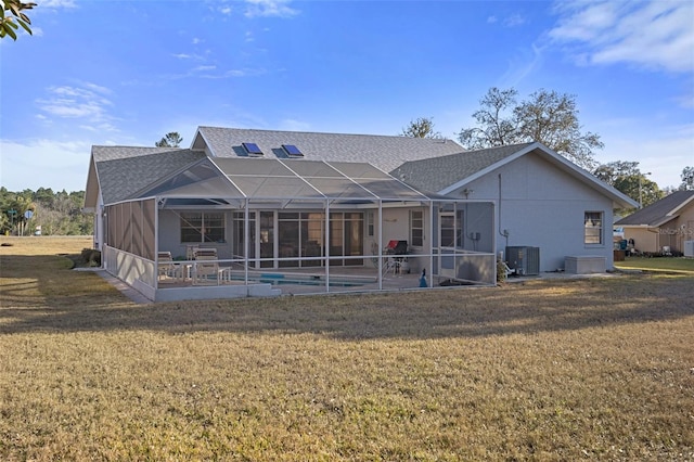 back of property with cooling unit, a patio, a lanai, and a lawn