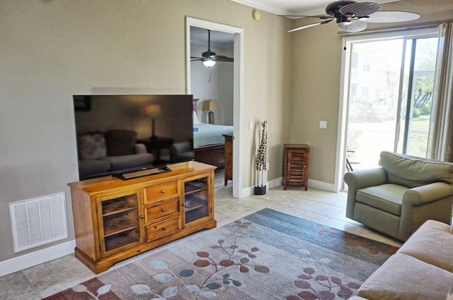 tiled living room featuring ceiling fan