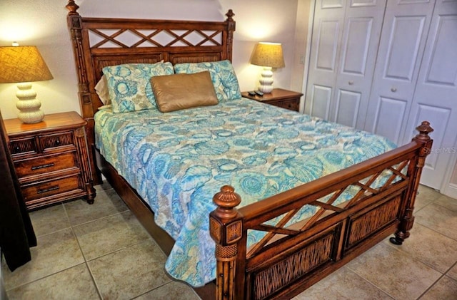 bedroom with a closet and light tile patterned floors